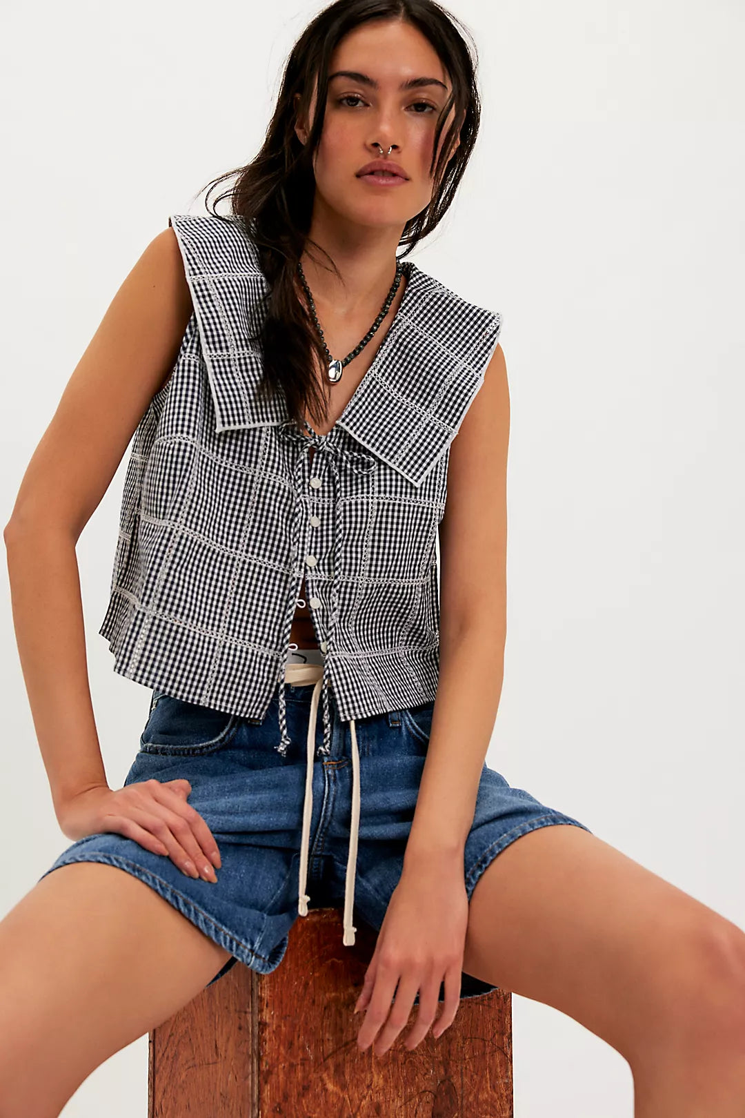 Woman wearing a checkered vest/top