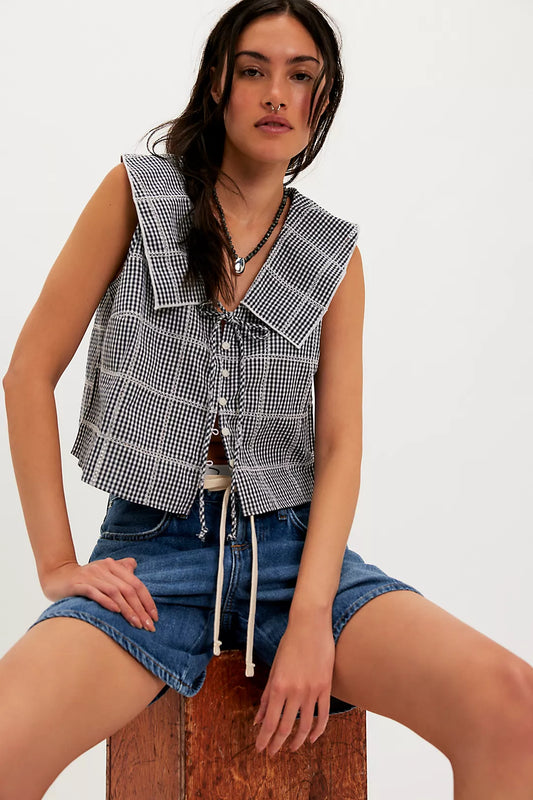 Woman wearing a checkered vest/top