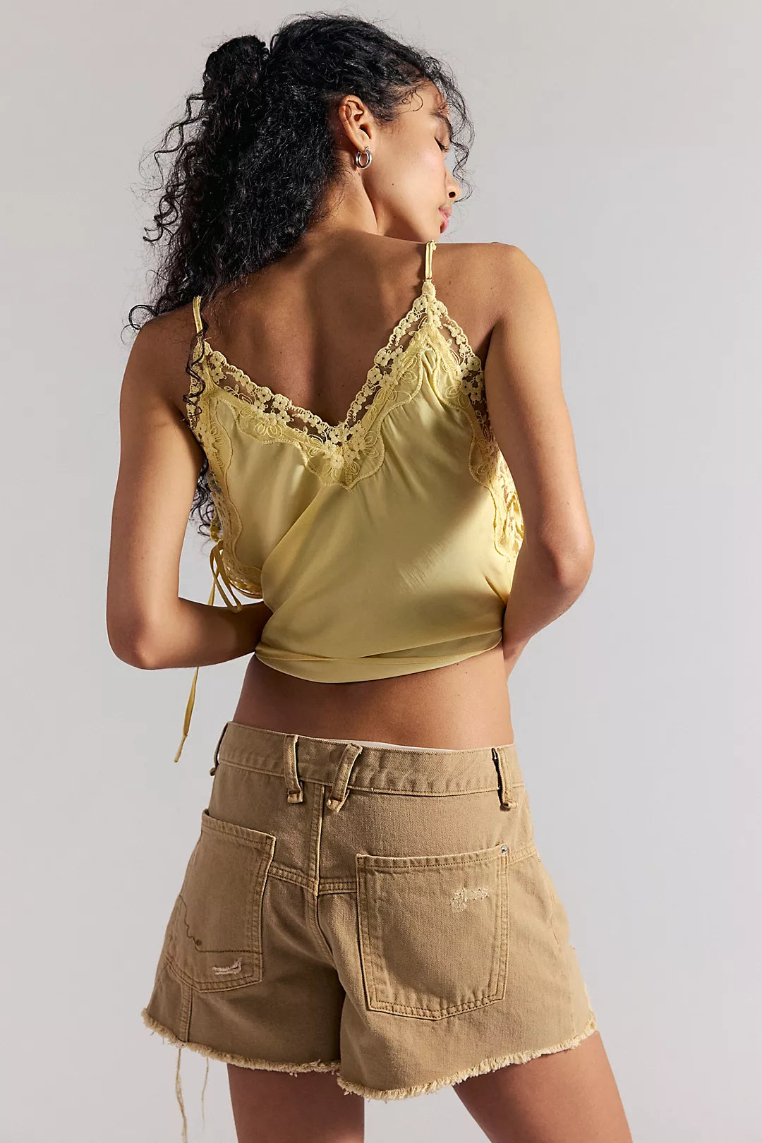 Woman wearing oat colored denim shorts
