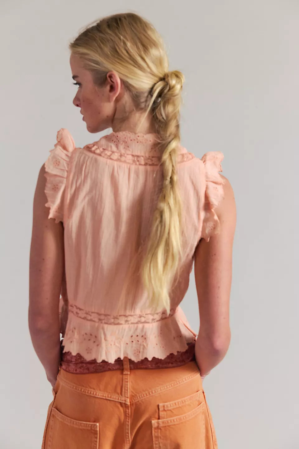 Woman wearing a peach lace top