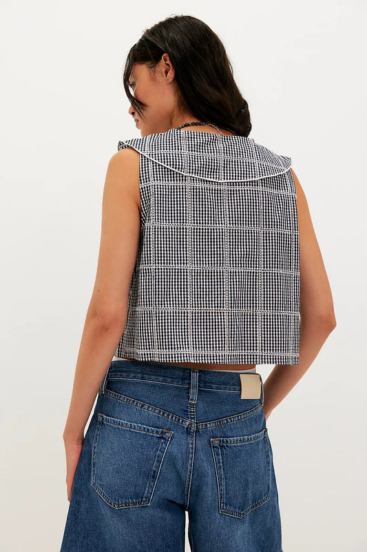 Woman wearing a checkered vest/top
