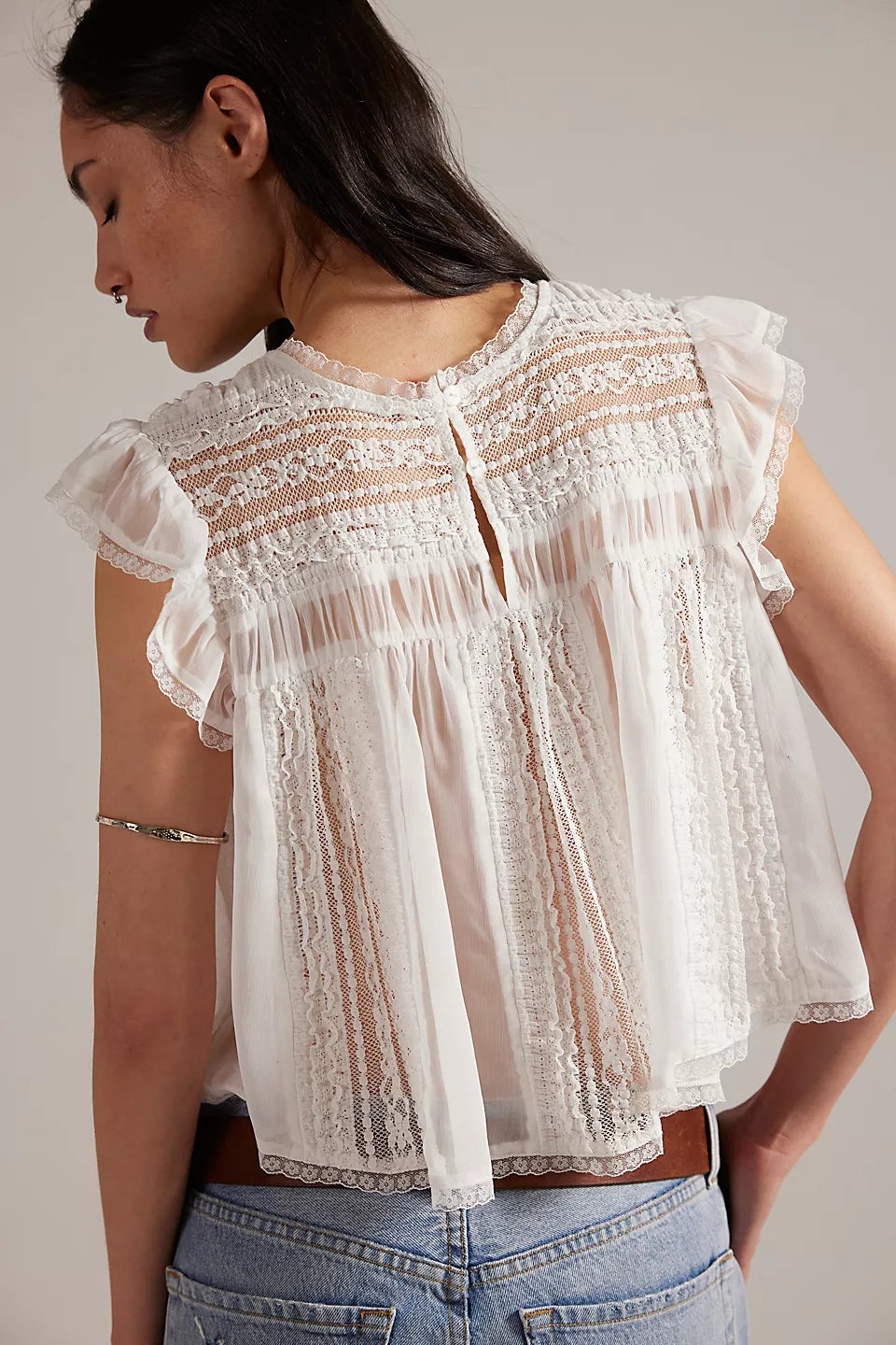 Woman wearing a white lace top 