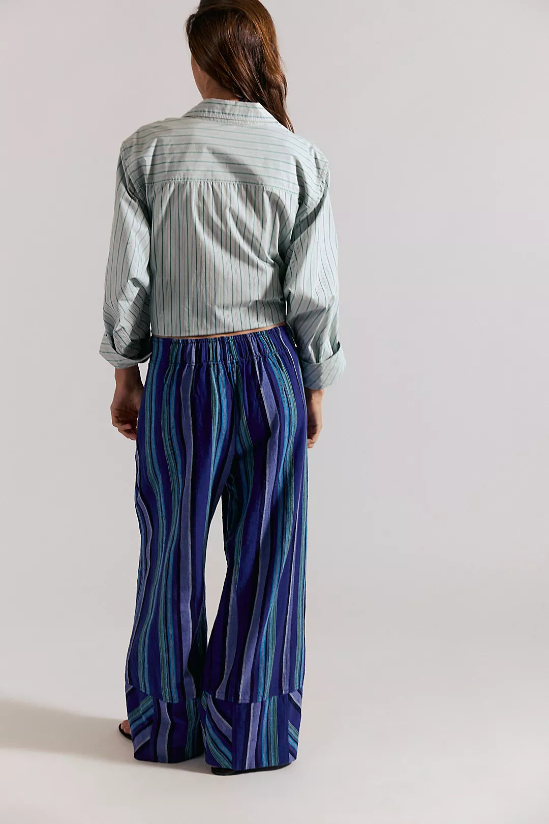 Woman wearing navy blue combo striped pants 