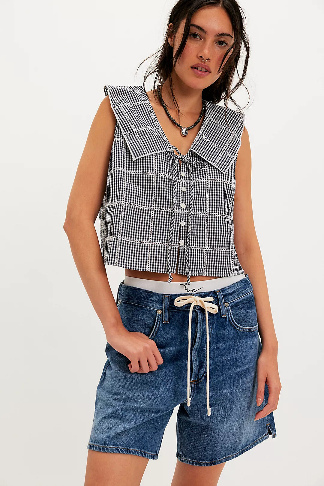 Woman wearing a checkered vest/top