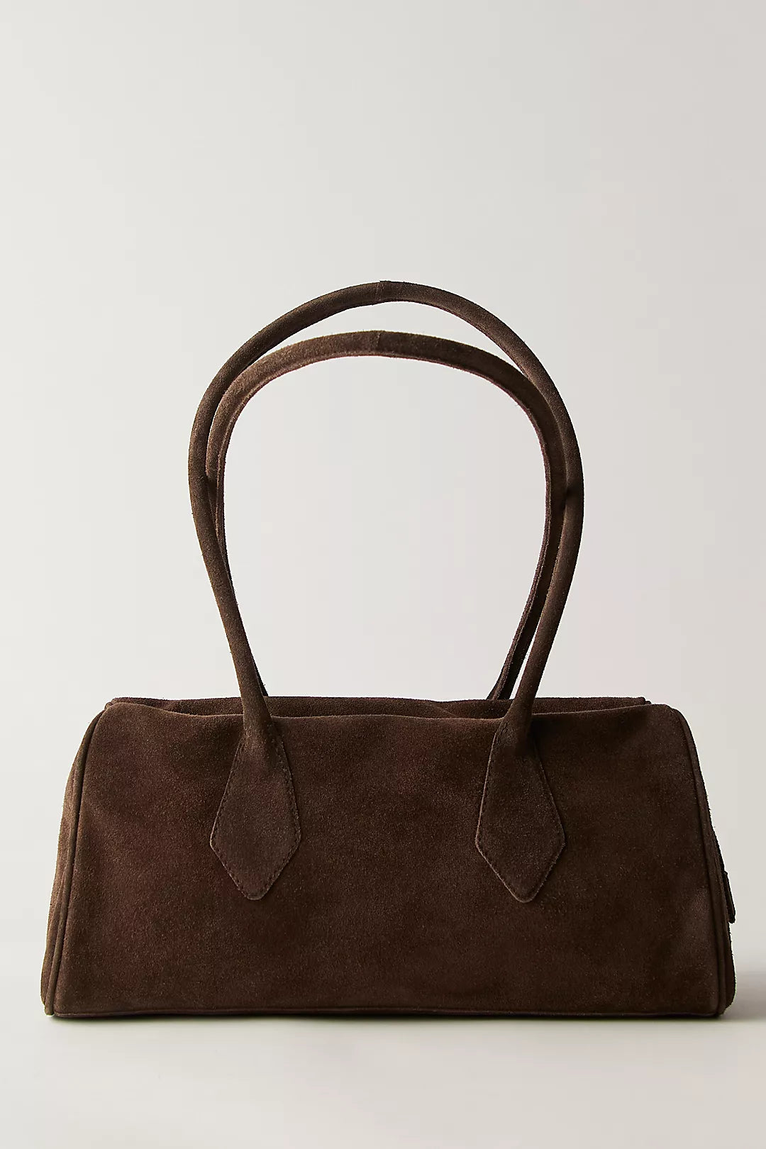 Chocolate suede shoulder bag with two handles, minimalist design, displayed on a neutral background.