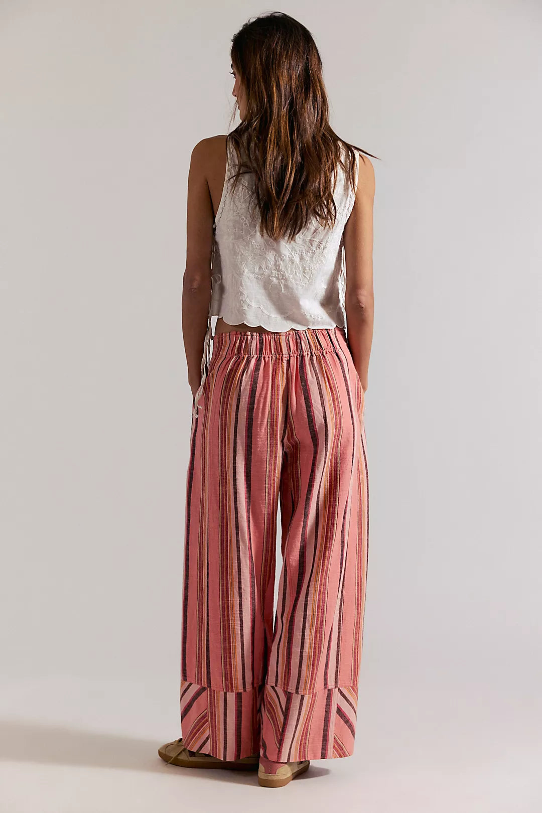 Woman wearing coral striped trousers 
