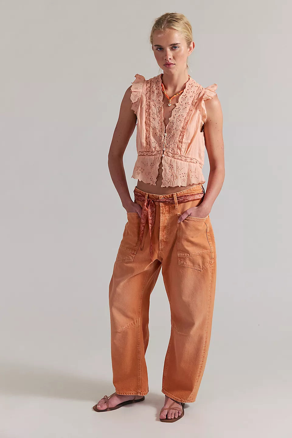 Woman wearing a peach lace top