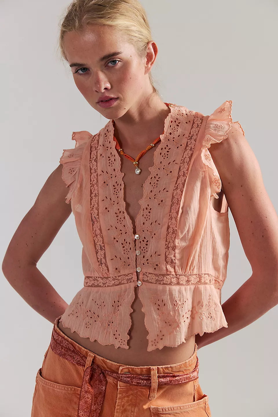 Woman wearing a peach lace top