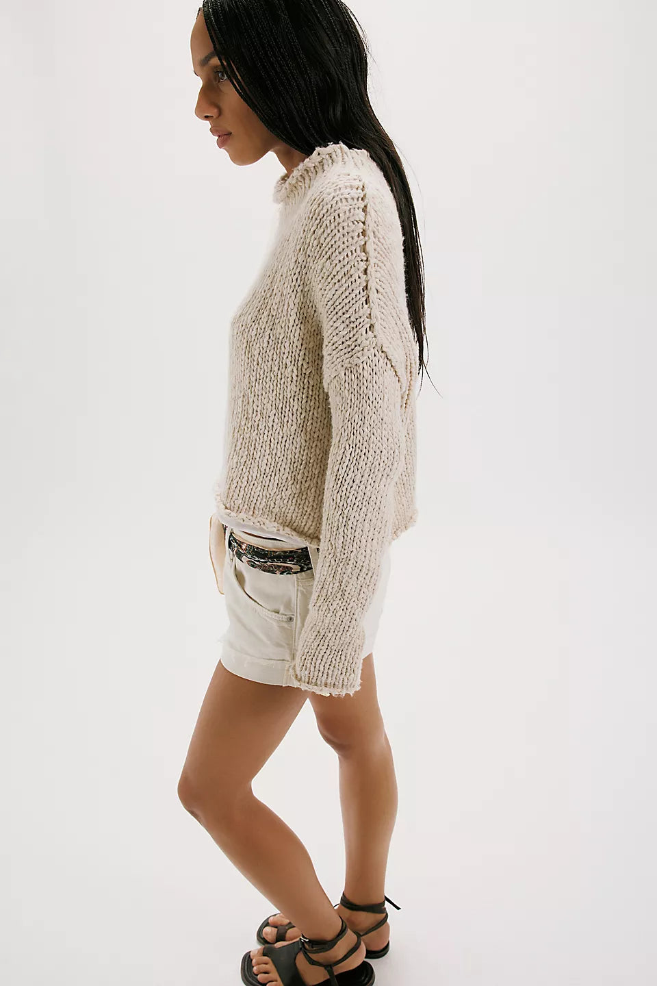 Woman wearing a beige knitted sweater 