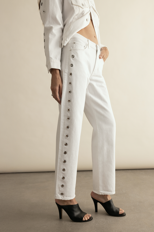 Woman wearing a white denim jeans with studded details